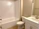 Clean bathroom with white tile and a bathtub at 9902 Belikove Manor Ave, Las Vegas, NV 89178