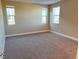 Spacious bedroom with three windows and carpet at 9902 Belikove Manor Ave, Las Vegas, NV 89178