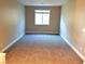 Bright bedroom with neutral carpeting and window at 9902 Belikove Manor Ave, Las Vegas, NV 89178