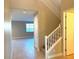 Two-story entryway with wooden staircase and tiled floors at 9902 Belikove Manor Ave, Las Vegas, NV 89178