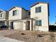 Two-story house with a brown garage door and landscaped front yard at 9902 Belikove Manor Ave, Las Vegas, NV 89178