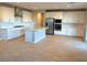 Modern kitchen with white cabinets, stainless steel appliances and an island at 9902 Belikove Manor Ave, Las Vegas, NV 89178
