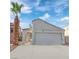 Single story home with gray garage door and desert landscaping at 3936 Rhine Way, Las Vegas, NV 89108