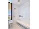 Bright bathroom showcasing a large shower, neutral tile, built-in bench, and a picture window view at 4915 Summit Overlook Dr, Las Vegas, NV 89135