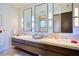 Modern bathroom featuring dual vanities, stone countertops, and elegant lighting fixtures at 4915 Summit Overlook Dr, Las Vegas, NV 89135