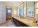 Bright bathroom with double vanity, large mirrors, and a walk-in shower at 4915 Summit Overlook Dr, Las Vegas, NV 89135