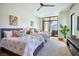 Bright bedroom with a ceiling fan, large window with views, and stylish decor at 4915 Summit Overlook Dr, Las Vegas, NV 89135