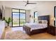 Bedroom with large windows offering mountain views, hardwood floors, and neutral decor at 4915 Summit Overlook Dr, Las Vegas, NV 89135