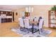 Elegant dining area featuring a modern chandelier, hardwood floors, and seamless access to the kitchen, perfect for entertaining at 4915 Summit Overlook Dr, Las Vegas, NV 89135