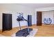 Bright exercise room with wood floors showcasing a folding screen and a modern treadmill at 4915 Summit Overlook Dr, Las Vegas, NV 89135