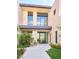Stunning home entrance with modern architecture, a tiled walkway, and beautiful landscaping, perfect for outdoor relaxation at 4915 Summit Overlook Dr, Las Vegas, NV 89135