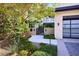 Elegant home featuring lush landscaping, a modern gate, and a contemporary design, creating a welcoming entrance at 4915 Summit Overlook Dr, Las Vegas, NV 89135