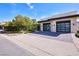 Modern home with a spacious driveway leading to a two-car garage with sleek, contemporary design and ample parking at 4915 Summit Overlook Dr, Las Vegas, NV 89135