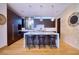 Modern kitchen featuring a marble island with barstool seating and stainless steel appliances at 4915 Summit Overlook Dr, Las Vegas, NV 89135