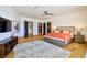 Spacious main bedroom featuring hardwood floors, a ceiling fan, and an en-suite bathroom at 4915 Summit Overlook Dr, Las Vegas, NV 89135