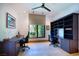 Bright office showcasing hardwood floors, built-in desk with shelving, and a ceiling fan at 4915 Summit Overlook Dr, Las Vegas, NV 89135