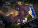 Aerial view of the property showcasing a distinctive red tile roof, circular driveway, and a refreshing backyard pool at 73 Princeville Ln, Las Vegas, NV 89113