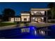 A stunning backyard with a pool and a modern home with large windows, perfect for relaxing and entertaining at 73 Princeville Ln, Las Vegas, NV 89113