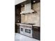 Gourmet kitchen with a professional grade Wolf range and stainless steel hood at 73 Princeville Ln, Las Vegas, NV 89113