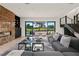 Contemporary living room with stone accent wall, modern fireplace, and large sliding doors to outdoor space at 73 Princeville Ln, Las Vegas, NV 89113