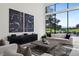 Bright living room featuring neutral décor, large windows with golf course views, and stylish furnishings at 73 Princeville Ln, Las Vegas, NV 89113