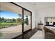 Bedroom with sliding glass doors and balcony overlooking the golf course at 73 Princeville Ln, Las Vegas, NV 89113