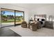Main bedroom featuring golf course views and a cozy seating area at 73 Princeville Ln, Las Vegas, NV 89113