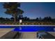 Relaxing poolside view featuring lounge chairs and a sparkling blue swimming pool with a golf course in the background at 73 Princeville Ln, Las Vegas, NV 89113