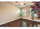 Neutral bedroom featuring hardwood floors, light walls, a ceiling fan, and natural light from the windows at 10909 Bramante Dr, Las Vegas, NV 89141