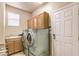 Well-equipped laundry room with a sink, cabinets for storage, and a side-by-side washer and dryer unit at 10909 Bramante Dr, Las Vegas, NV 89141