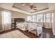 Spacious main bedroom features tray ceilings, ceiling fan, hardwood floors, and lots of natural light at 10909 Bramante Dr, Las Vegas, NV 89141
