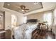 Main bedroom features a ceiling fan, hardwood floors, and ensuite bathroom access at 10909 Bramante Dr, Las Vegas, NV 89141