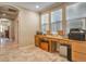 A home office with a built in desk and lots of natural light at 10909 Bramante Dr, Las Vegas, NV 89141