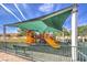 Outdoor playground with slides and play structure with sun shade in a community park at 10909 Bramante Dr, Las Vegas, NV 89141