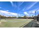 Outdoor tennis court within a fenced area offering recreational opportunities under a clear blue sky at 10909 Bramante Dr, Las Vegas, NV 89141