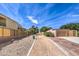 Walking path with gravel and concrete borders surrounded by landscaping and nearby buildings at 10909 Bramante Dr, Las Vegas, NV 89141