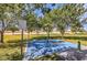 Community park water play feature with a blue splash pad, set amongst mature trees and manicured lawns at 10909 Bramante Dr, Las Vegas, NV 89141