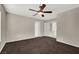 Bedroom with dark carpet, ceiling fan, and access to other rooms at 10914 Fintry Hills St, Las Vegas, NV 89141
