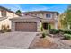 Two-story house with tan exterior, brown roof, and paved driveway at 10914 Fintry Hills St, Las Vegas, NV 89141