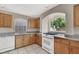 Kitchen with oak cabinets, granite counters, and a gas range at 10914 Fintry Hills St, Las Vegas, NV 89141