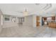 Open living and kitchen area with tile floors and chandelier at 10914 Fintry Hills St, Las Vegas, NV 89141