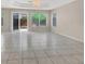 Large living room with tile floors and sliding glass doors at 10914 Fintry Hills St, Las Vegas, NV 89141