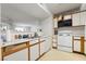 White kitchen with appliances and wood cabinets at 2300 E Silverado Ranch Blvd # 1165, Las Vegas, NV 89183
