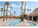Community pool and spa with palm trees and seating at 2300 E Silverado Ranch Blvd # 1165, Las Vegas, NV 89183