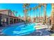 Community pool with palm trees and lounge chairs at 2300 E Silverado Ranch Blvd # 1165, Las Vegas, NV 89183