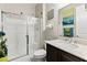 Well-lit bathroom featuring a glass-enclosed shower and modern vanity at 7380 Abundant Harvest Ave, Las Vegas, NV 89131