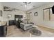 Comfortable bedroom with a love seat, ceiling fan, and a dresser next to the bed at 7380 Abundant Harvest Ave, Las Vegas, NV 89131