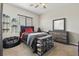 This bedroom features a ceiling fan and a dresser next to a storage case for sneakers at 7380 Abundant Harvest Ave, Las Vegas, NV 89131