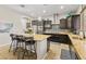 Modern kitchen featuring granite countertops, stainless steel appliances, and stylish pendant lighting at 7380 Abundant Harvest Ave, Las Vegas, NV 89131