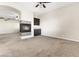 Open concept living room with a fireplace, a wet bar, and carpeted floors at 7380 Abundant Harvest Ave, Las Vegas, NV 89131